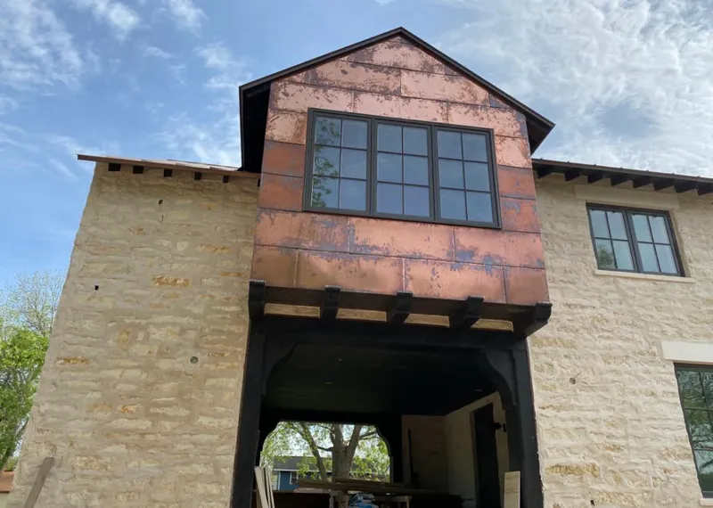 Copper metal panel facade on a stone building for Metal Roof Coating in Center