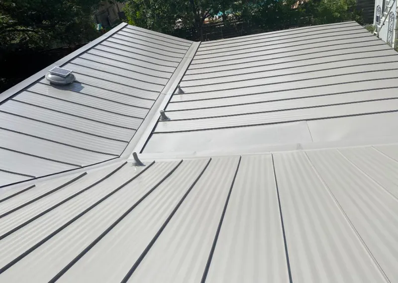 Solar attic fan installed on a metal roof for Roof Ventilation in Center